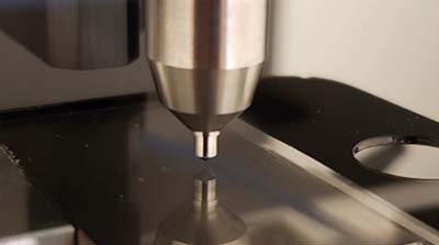 Glass sample in the Rtec Instruments scratch testing instrument